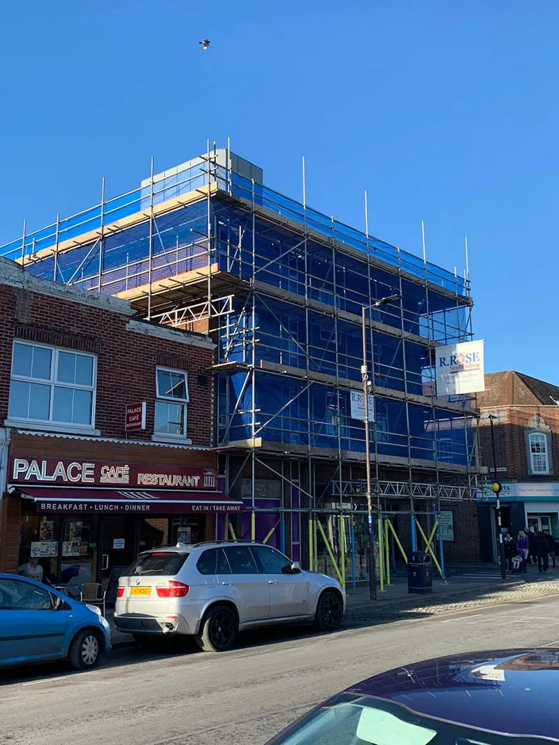 large building with blue scaffolding around wthe area